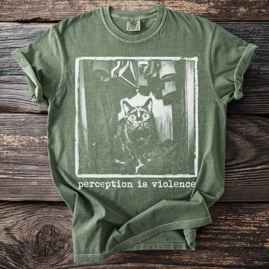 Green t-shirt with a distressed graphic of a cat and the text "Perception is Violence".