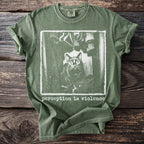 Green t-shirt with a distressed graphic of a cat and the text "Perception is Violence".