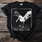 Black t-shirt with a seagull in flight and text "i take what i wa".