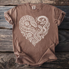 Brown t-shirt with white heart design of intertwined snakes and roses.