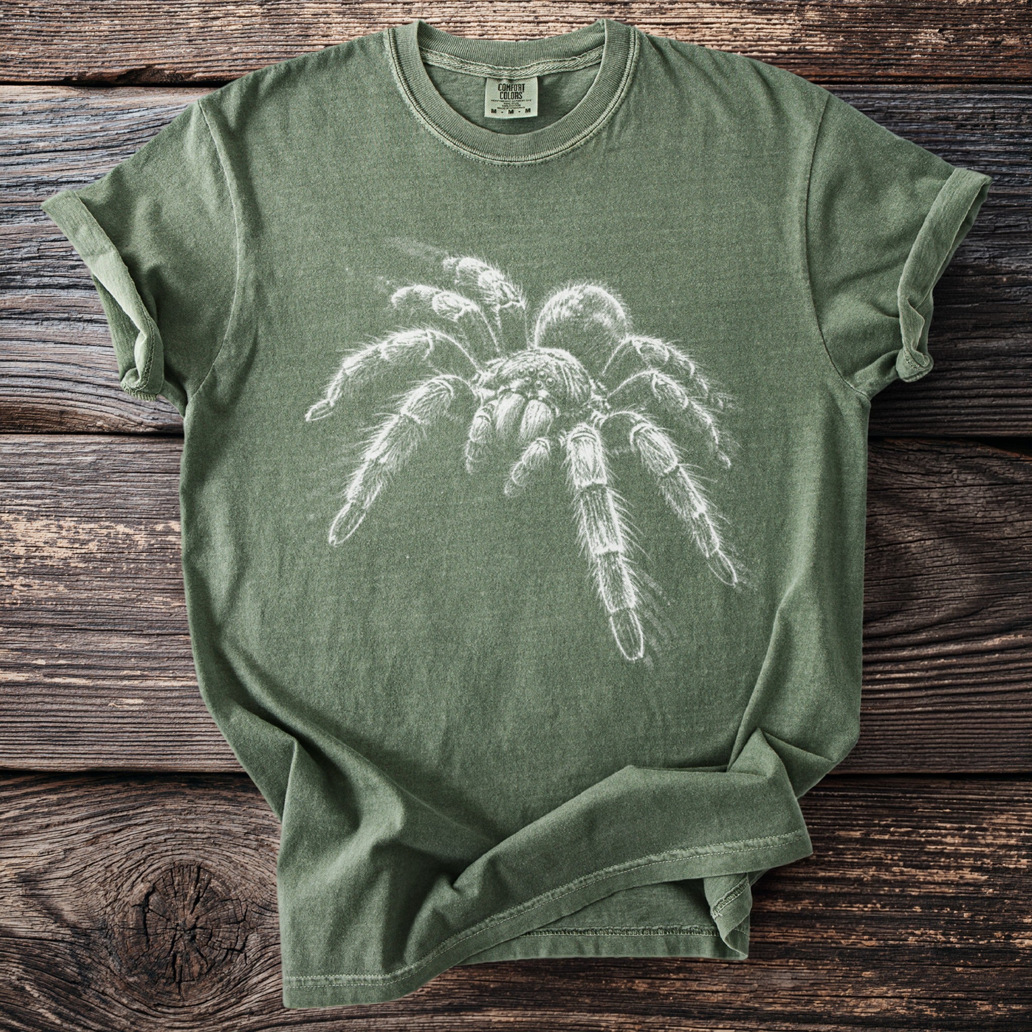 Green t-shirt with a white sketch of a tarantula and "Comfort Colors" label.