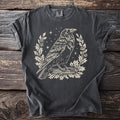 Dark gray t-shirt with raven, oak leaves, and stars graphic print.
