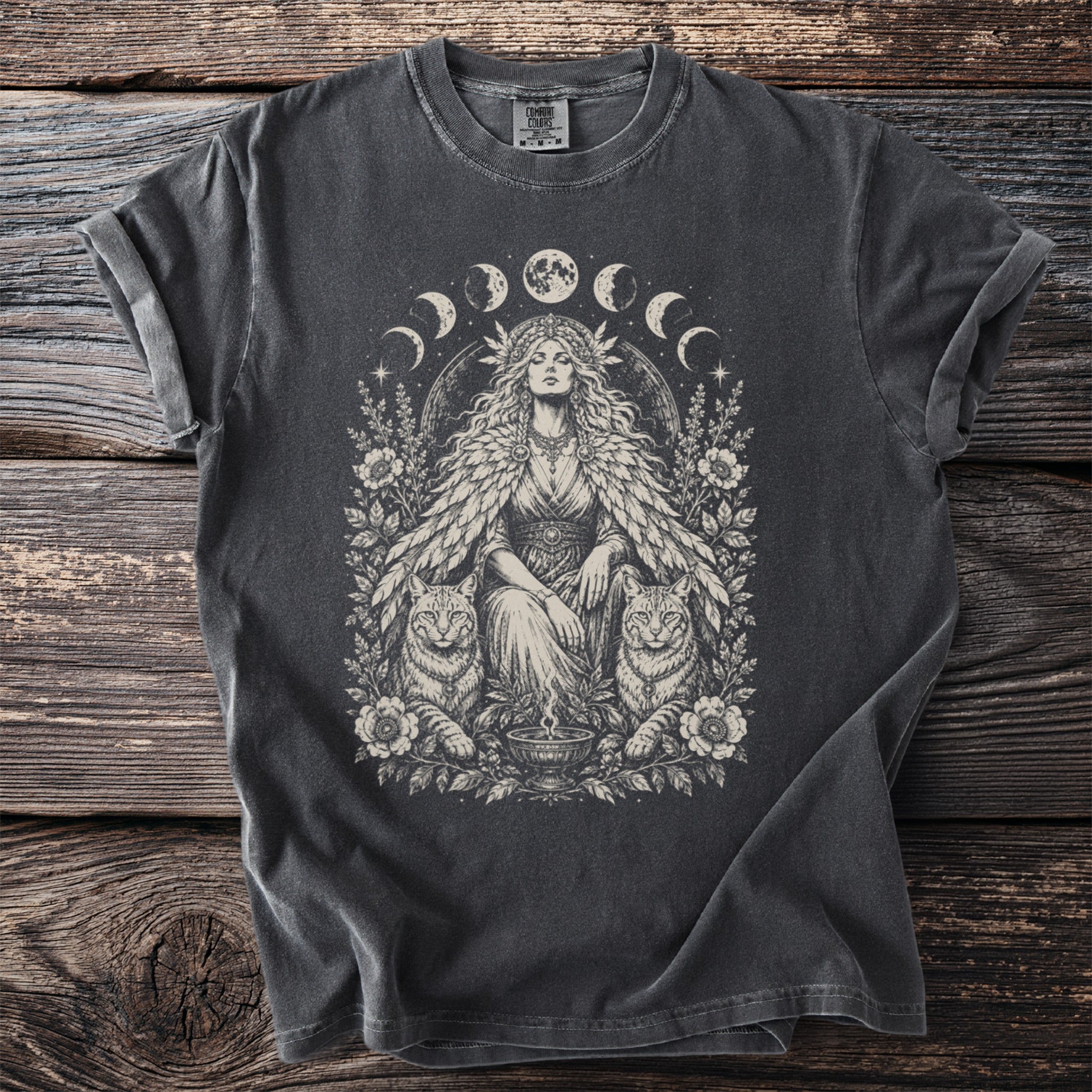 T-shirt with a mystical goddess, two cats, floral motifs, and moon phases illustration.