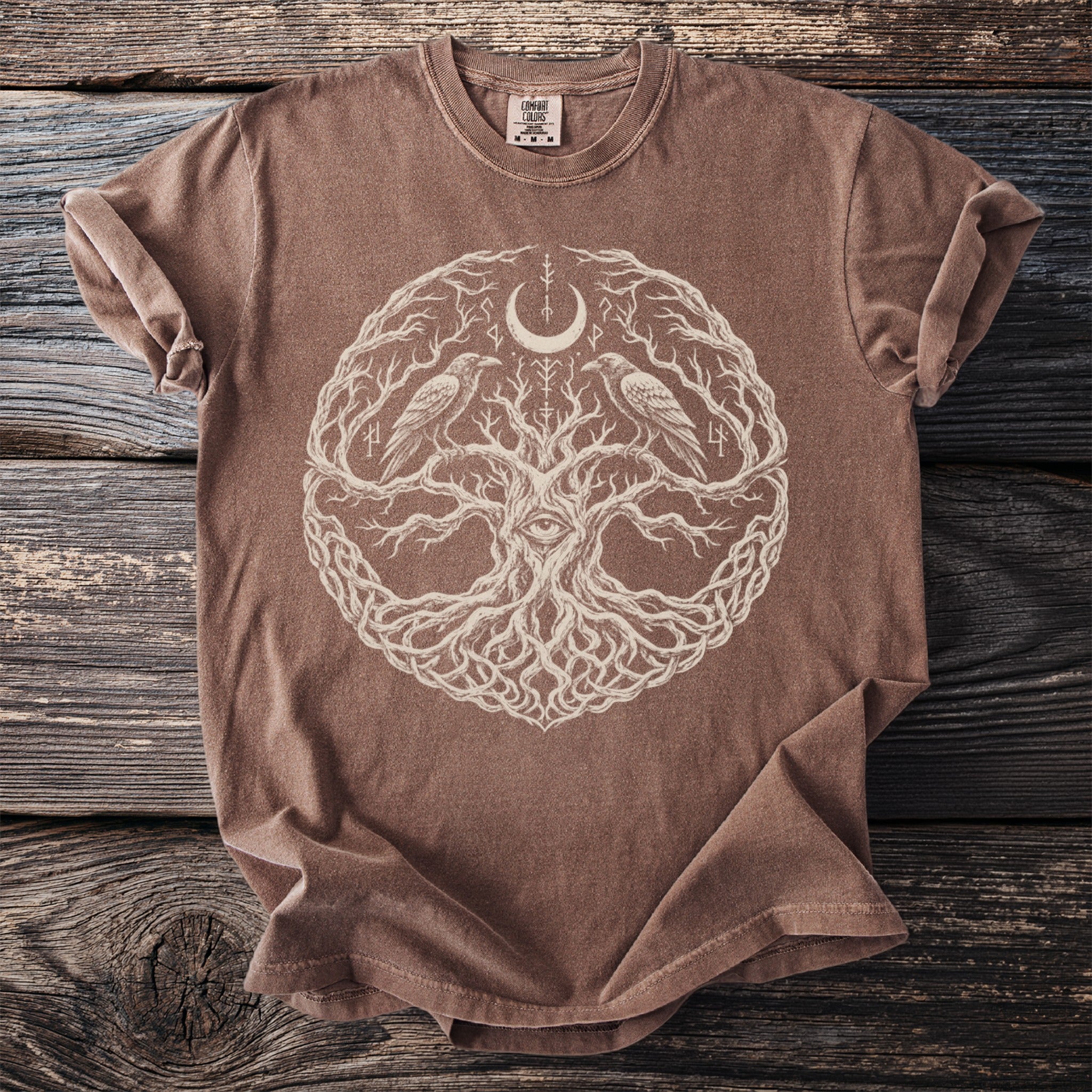 Brown t-shirt with white tree of life, crescent moon, eye, and rune print.