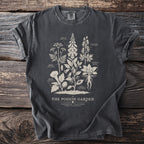 Dark grey t-shirt with illustrated poisonous plants and text "The Poison Garden".