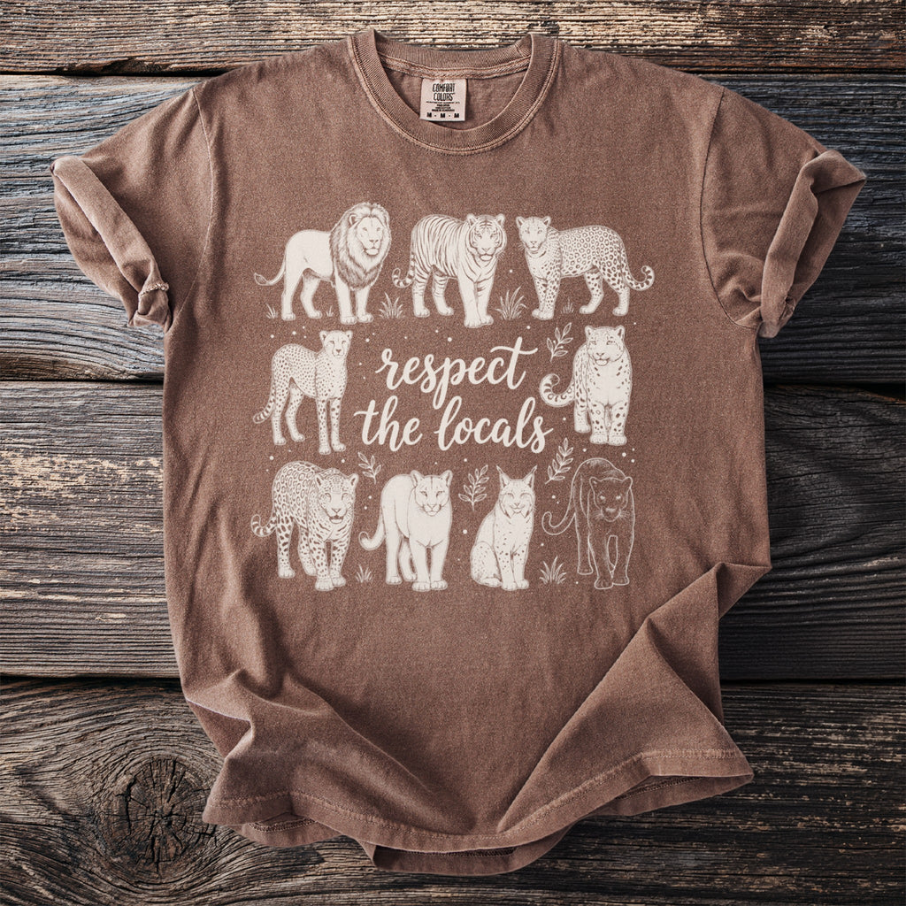 Brown t-shirt with white graphic of various big cats and text reading "respect the locals".