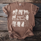 Brown t-shirt with white graphic of various big cats and text reading "respect the locals".