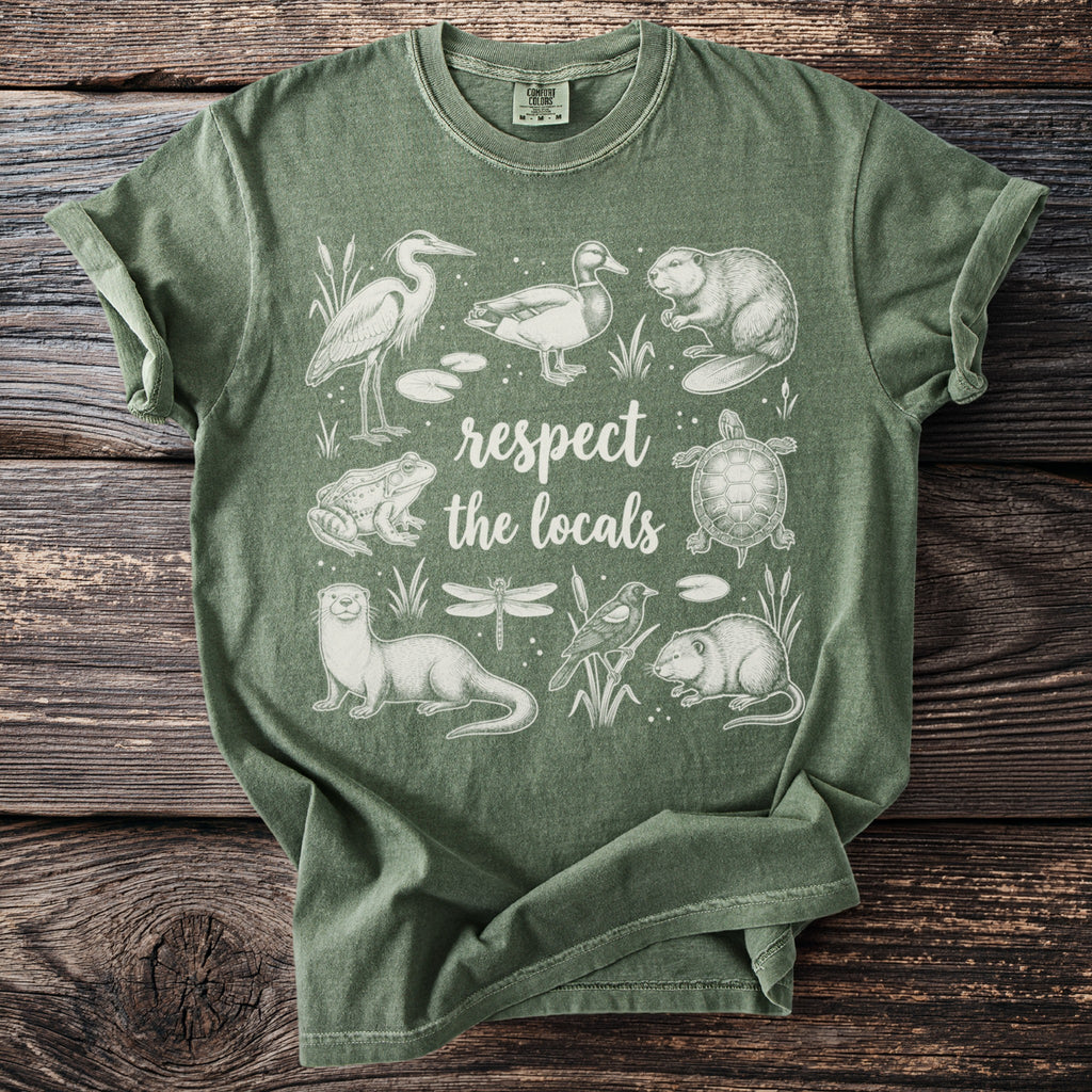 Green t-shirt with hand-drawn wildlife illustrations and "respect the locals" text.