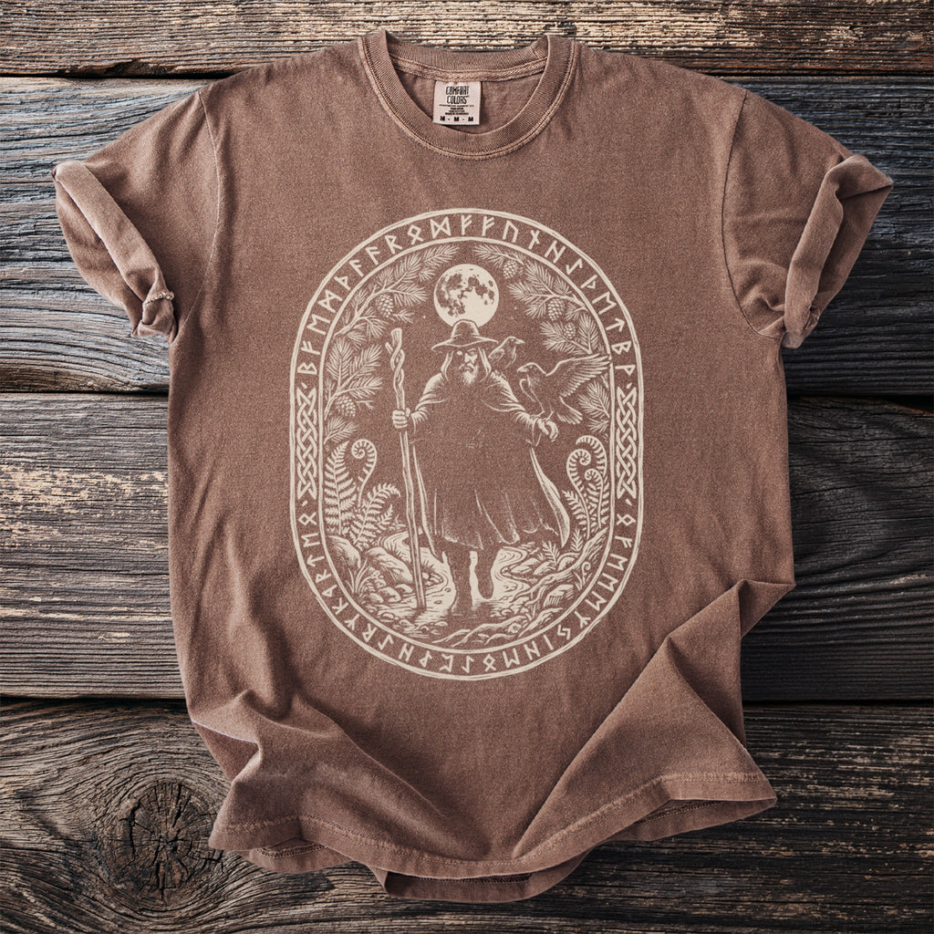 Brown t-shirt with an oval print of a wizard, ravens, and runes under a moon.
