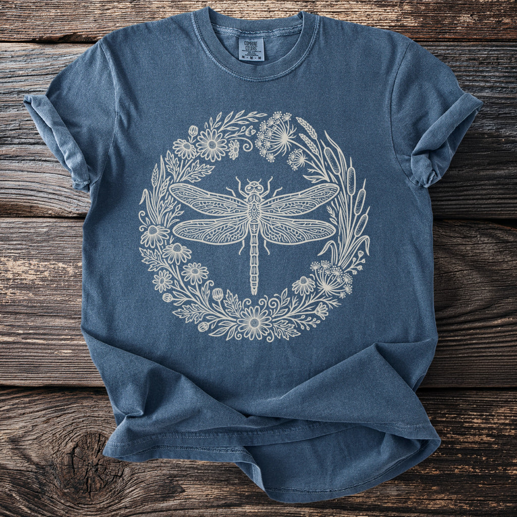 Dark blue t-shirt with cream dragonfly and floral wreath design.