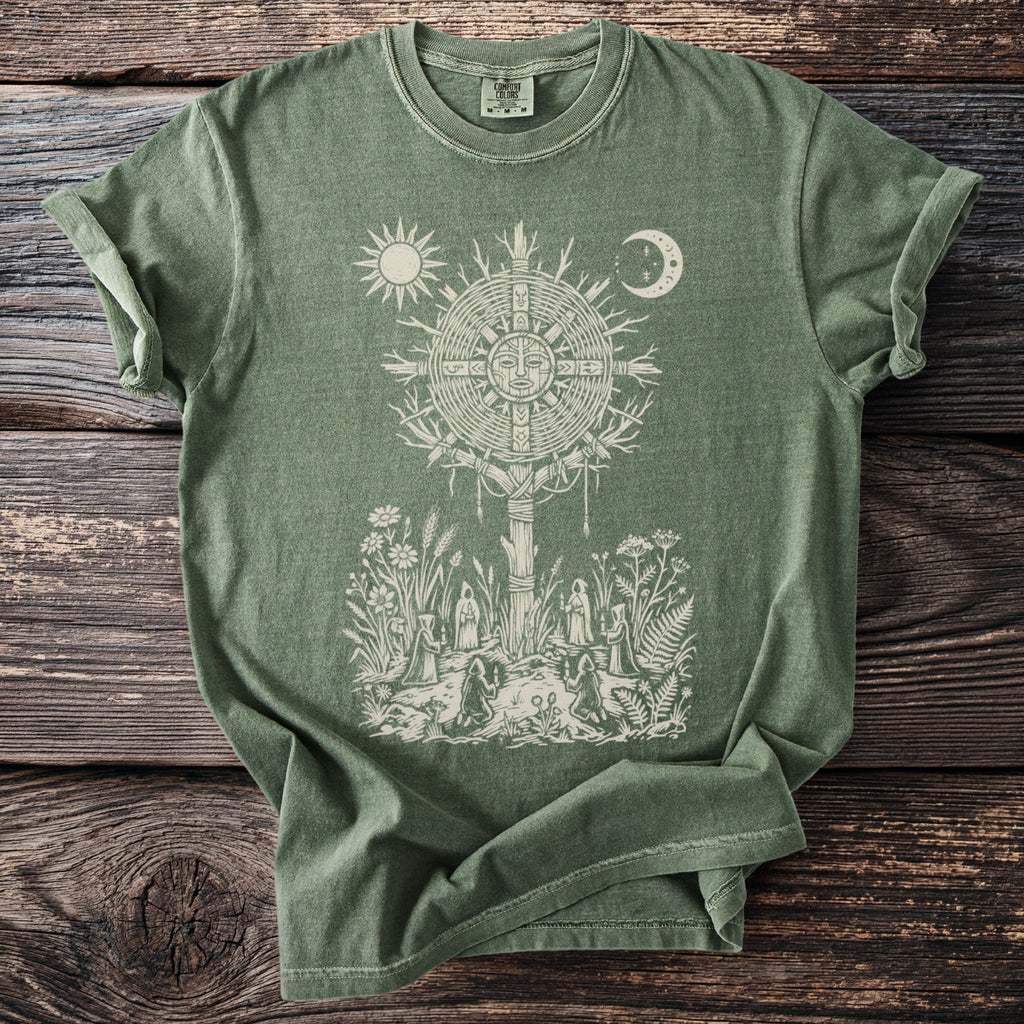 Green t-shirt with sun, moon, and druidic scene graphic of figures in a circle.
