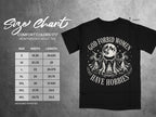 Black Comfort Colors 1717 t-shirt with "God forbid women have hobbies" graphic and size chart.