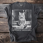 Dark grey t-shirt with a print of a cat sitting on steps and the words "emotionally unavailable".