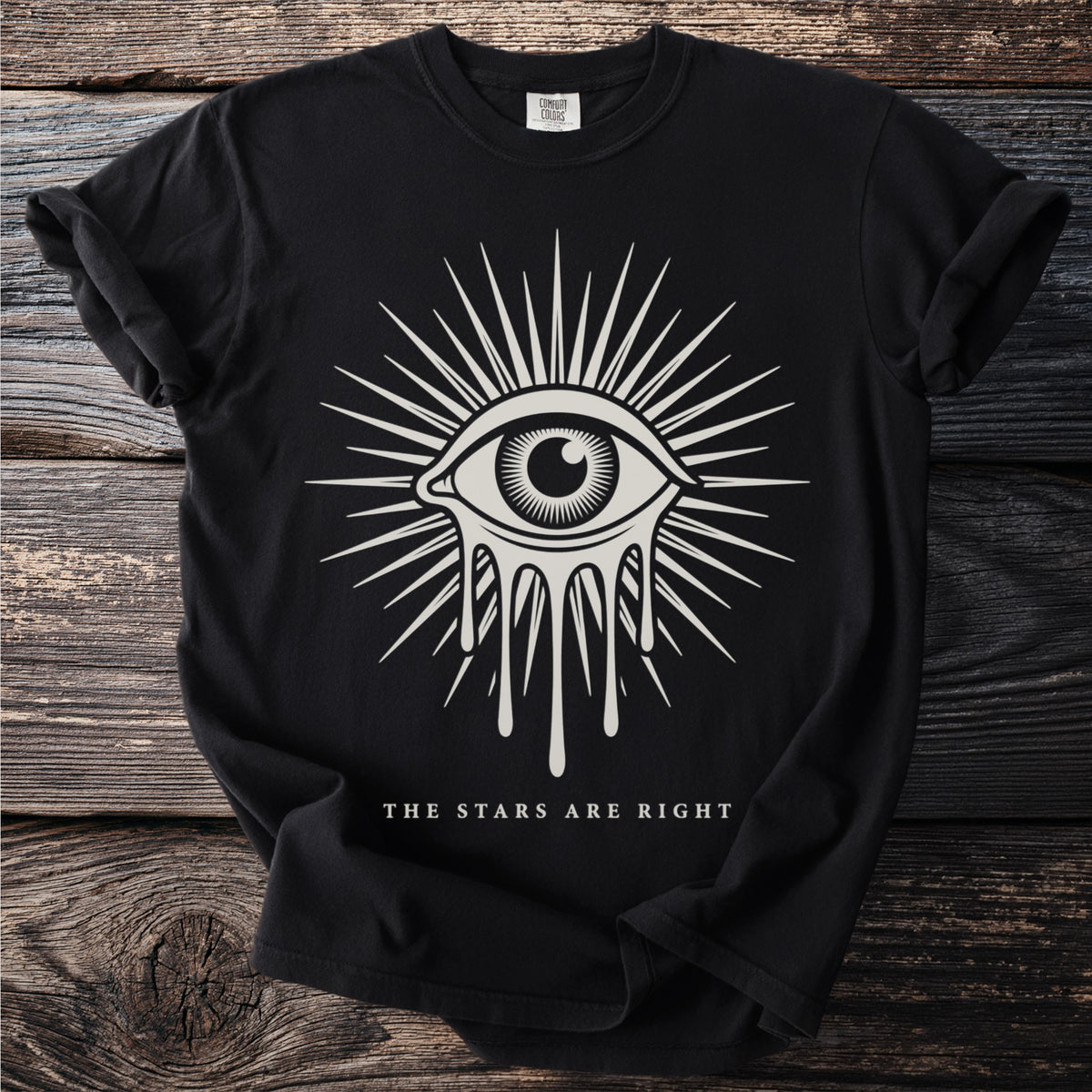 Black t-shirt with a white dripping eye design and text "THE STARS ARE RIGHT".