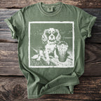 Green t-shirt with a graphic of a dog wearing sunglasses and holding a drink.