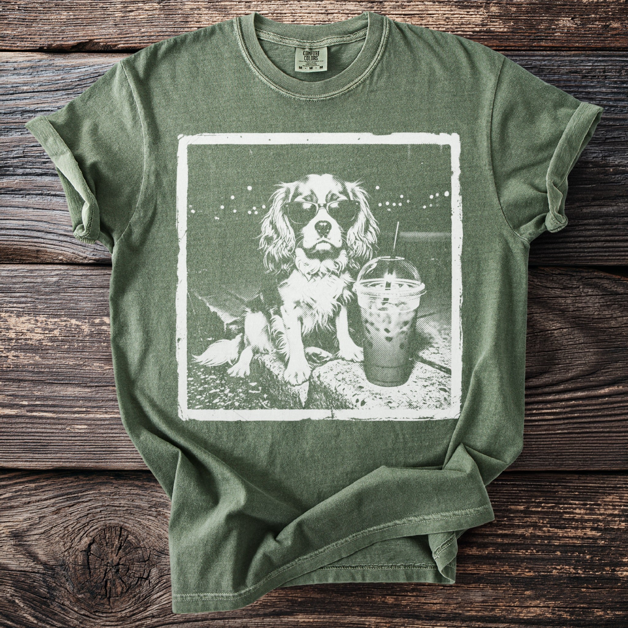 Green t-shirt with a graphic of a dog wearing sunglasses and holding a drink.