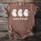 Brown t-shirt with three white ghosts in Santa hats, "Spooky & Bright" text.