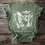 Green t-shirt with white graphic of figures in a cornfield, holding pumpkin, text "girls will be girls".