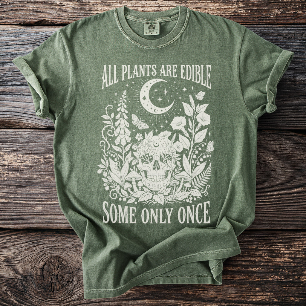 Green t-shirt with "All Plants Are Edible Some Only Once" and floral skull design.