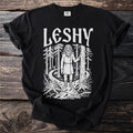 Black t-shirt with white print of a forest scene and the word "Leshy".