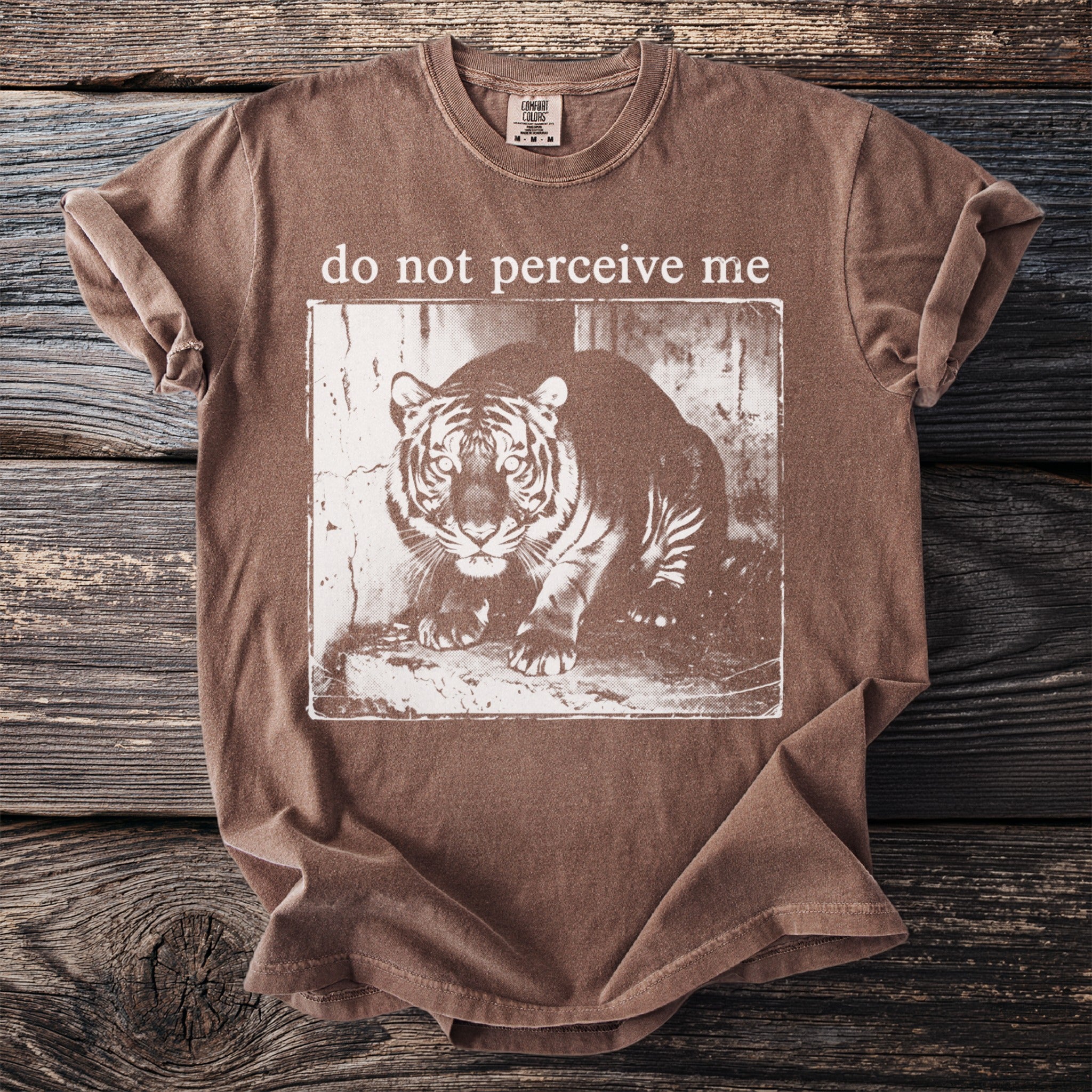 Brown t-shirt with a distressed tiger graphic and "do not perceive me" text.