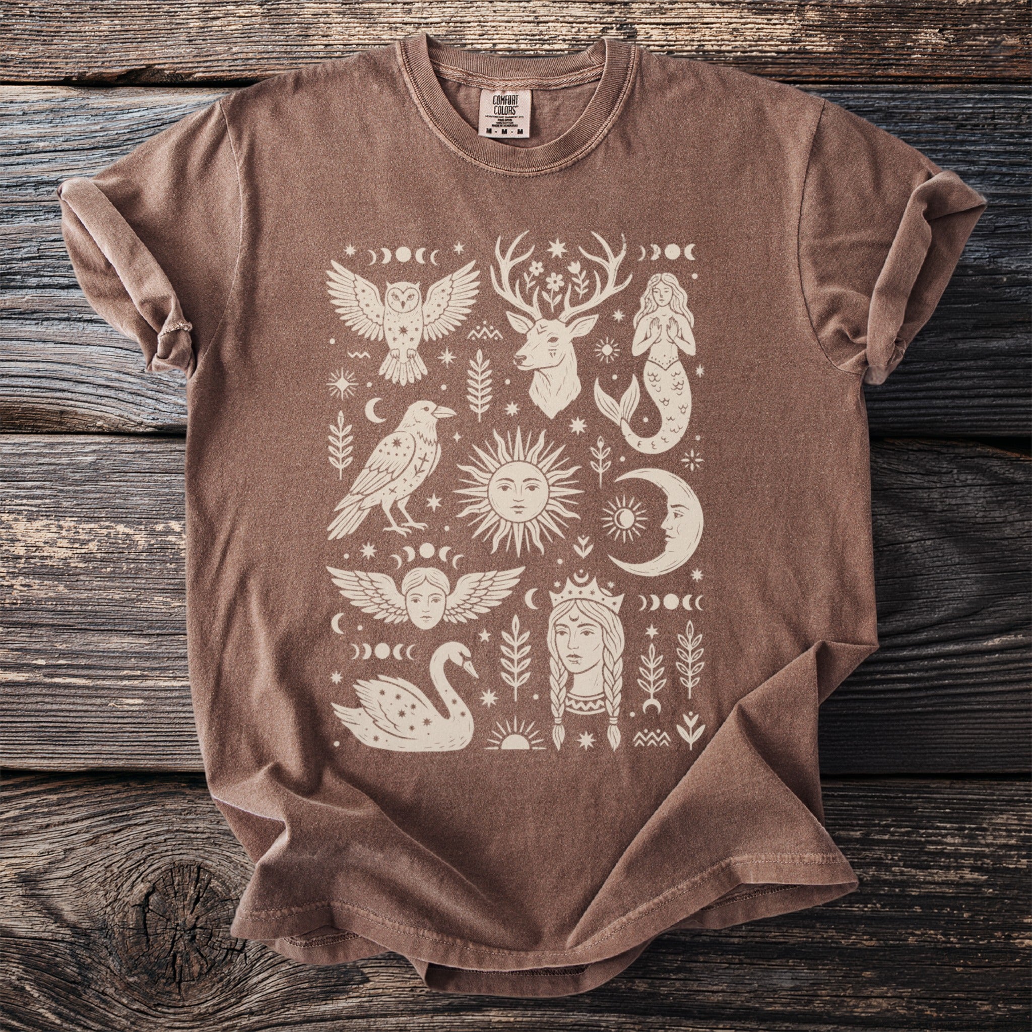 Brown t-shirt with mystical celestial and animal illustrations in cream