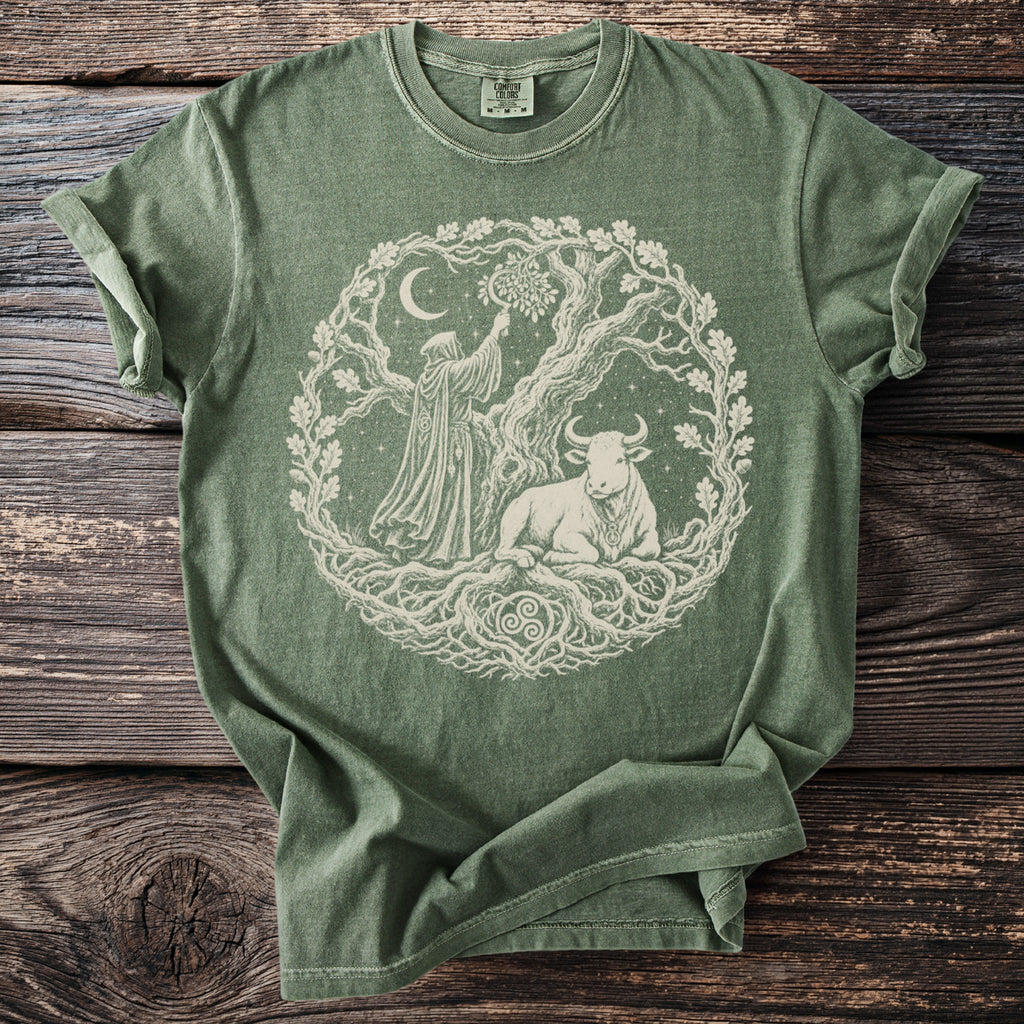 Green t-shirt with a white graphic of a hooded figure reaching to a tree and a bull.