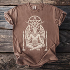 Brown t-shirt with Baphomet symbol, seated figure, and candles graphic.