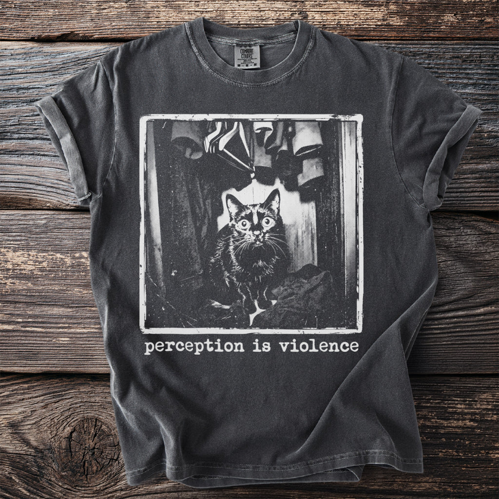 Dark t-shirt with black and white print of a cat in a closet and text "perception is violence".
