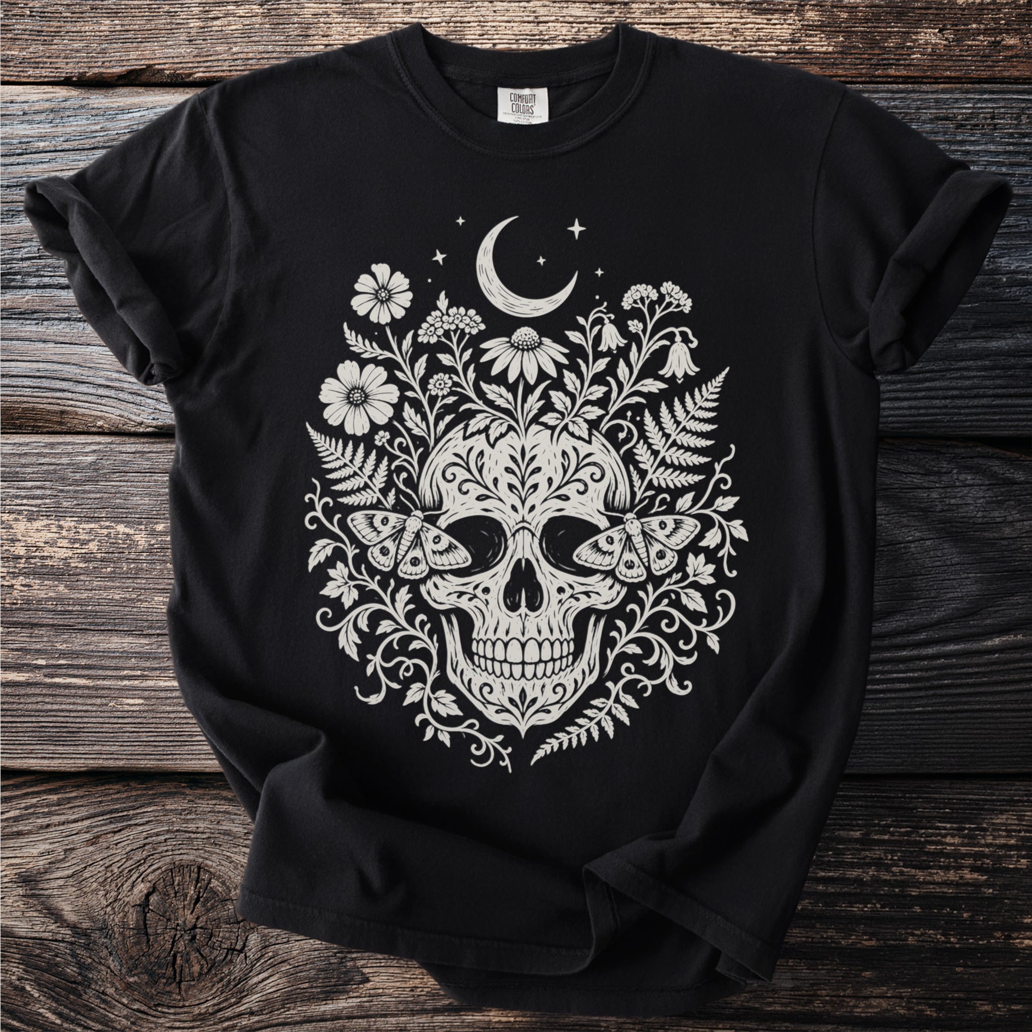 Black t-shirt with white skull, moths, flowers, and moon design.