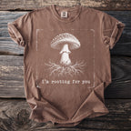 Brown t-shirt with a mushroom and roots graphic and text "i'm rooting for you".