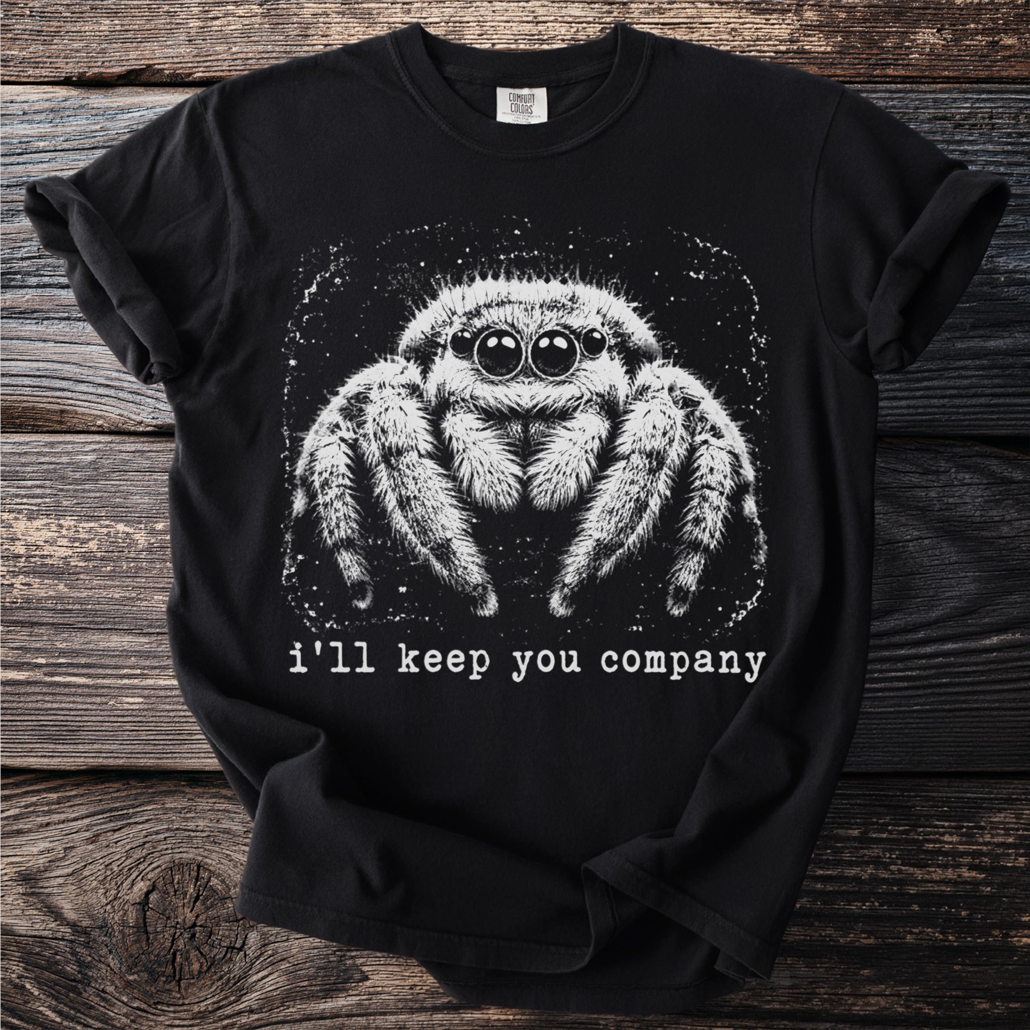 Black t-shirt with white graphic of a jumping spider and text "i'll keep you company".