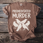 Brown t-shirt with white text "PREMEDITATED MURDER" above a flock of ravens.