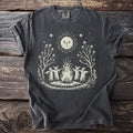 Dark gray t-shirt with a cream graphic of a campfire with three figures and a sun.
