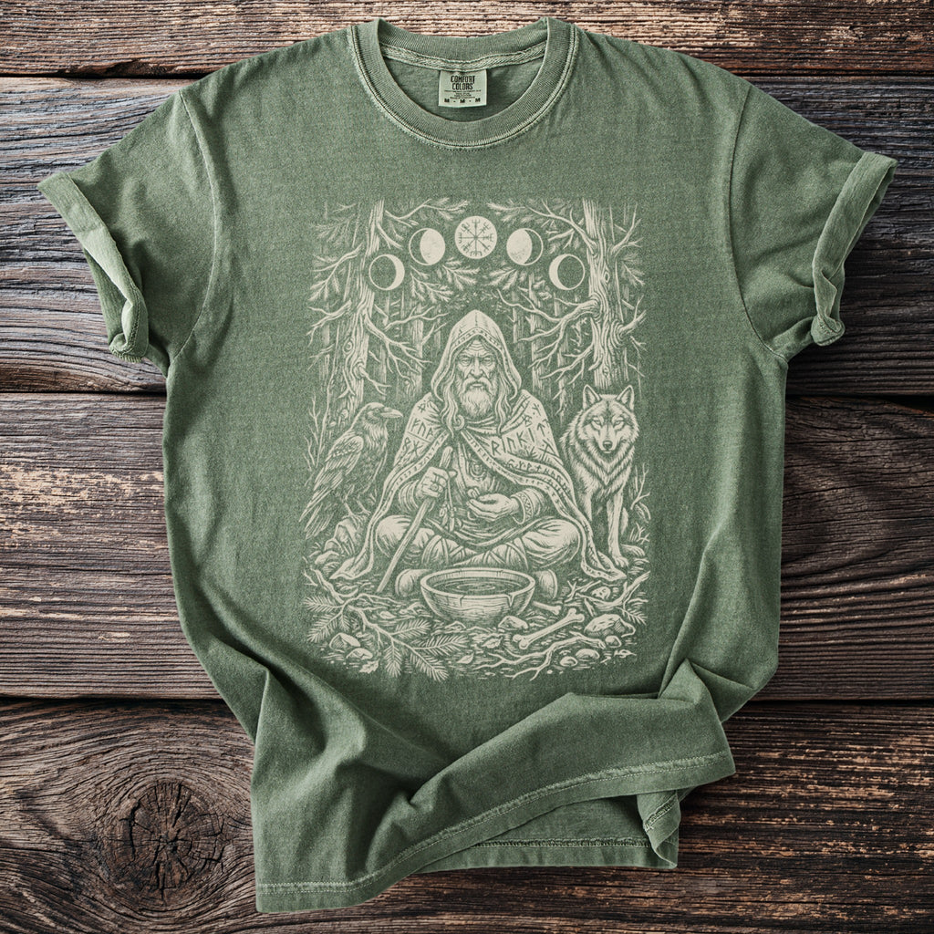 Green t-shirt with a vintage-style print of a seated bearded man with animals and woodland symbols.
