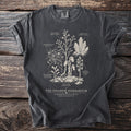 Dark t-shirt with botanical illustration of parasitic plants labeled "The Shadow Herbarium".