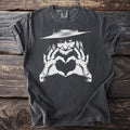 Dark gray t-shirt with a white graphic of a witch making a heart shape.