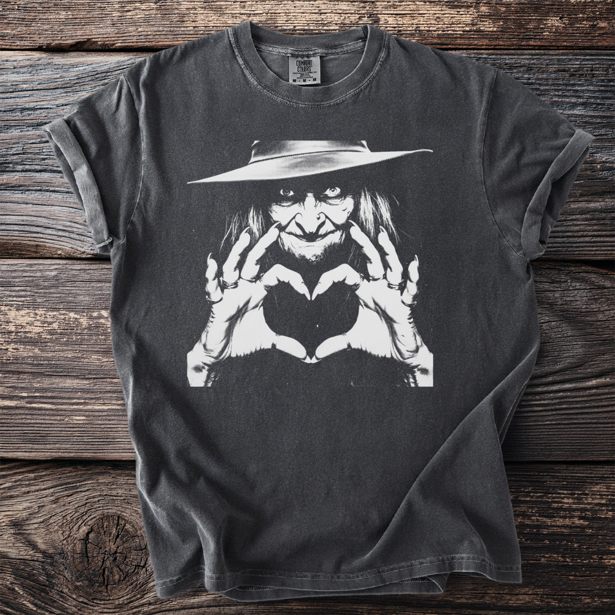 Dark gray t-shirt with a white graphic of a witch making a heart shape.