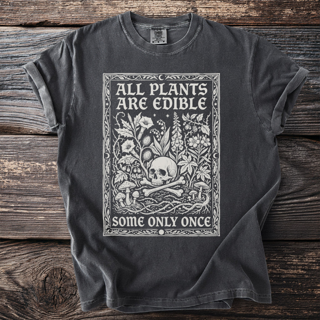 Dark grey t-shirt with white text and illustration of skull, bones, and plants.