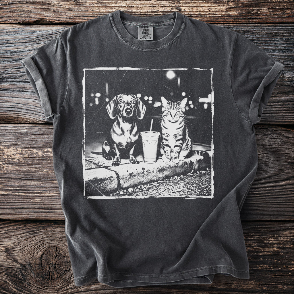 Dark grey t-shirt with a black and white graphic of a dachshund and cat with a drink.
