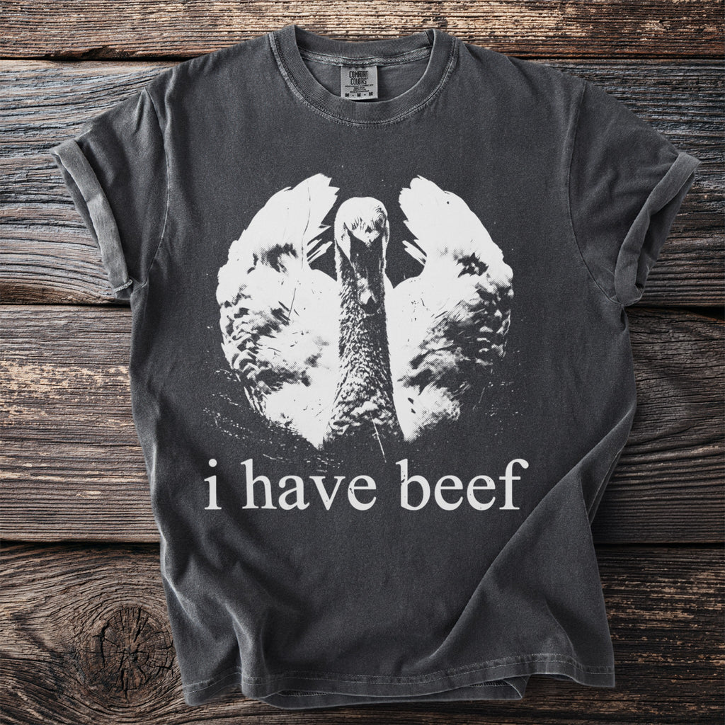 Dark gray t-shirt with white print of a goose and text "i have beef".