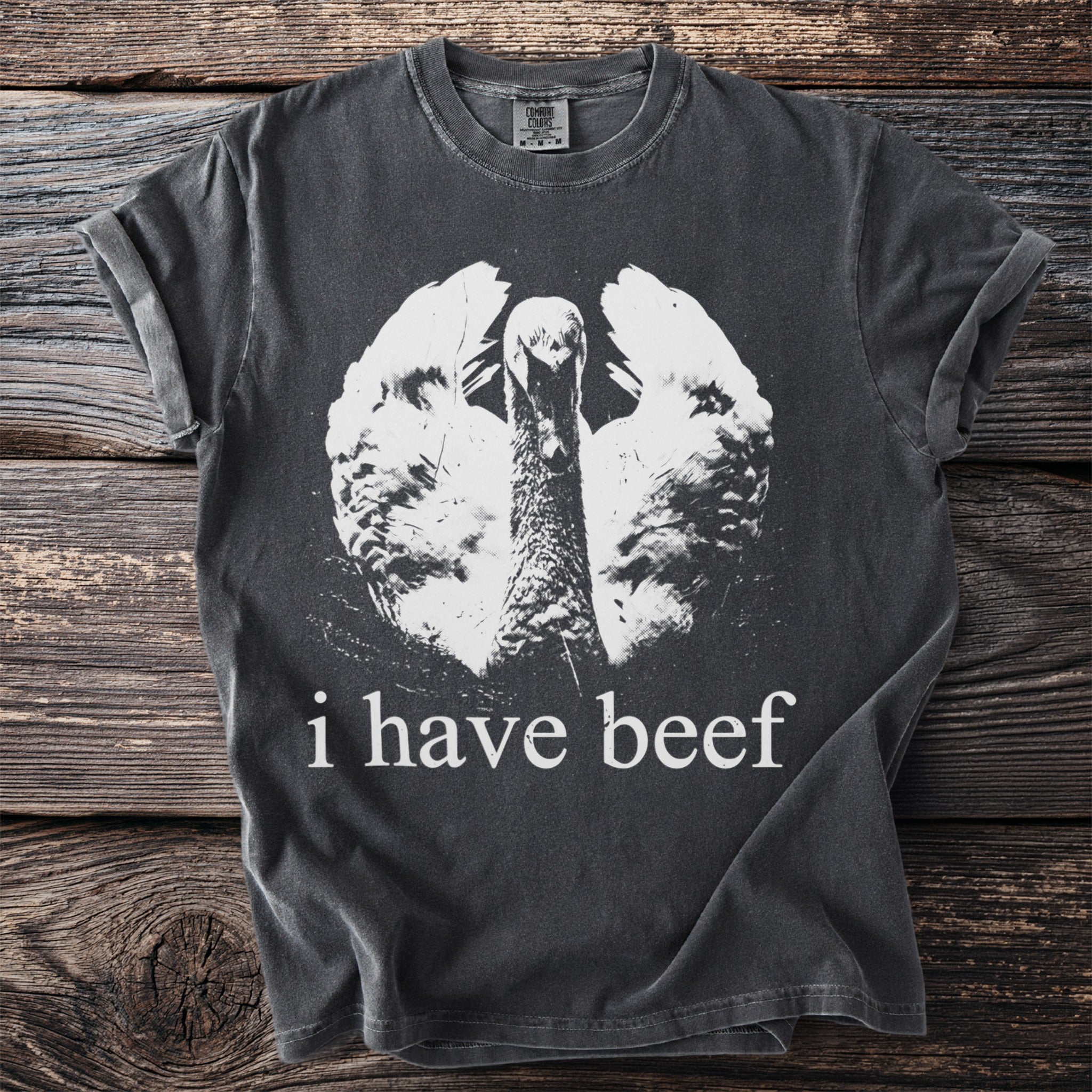 Dark gray t-shirt with white print of a goose and text "i have beef".