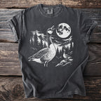 Graphic t-shirt with geese, mountains, trees, and a full moon at night.
