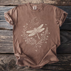 Brown Comfort Colors t-shirt with a white line art dragonfly and floral design.