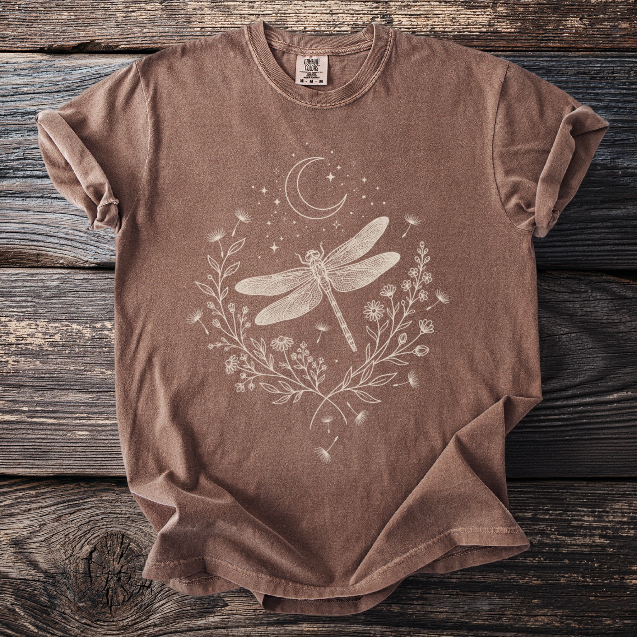 Brown Comfort Colors t-shirt with a white line art dragonfly and floral design.
