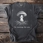 Dark t-shirt with graphic of mushroom and roots with text "i'm rooting for you."