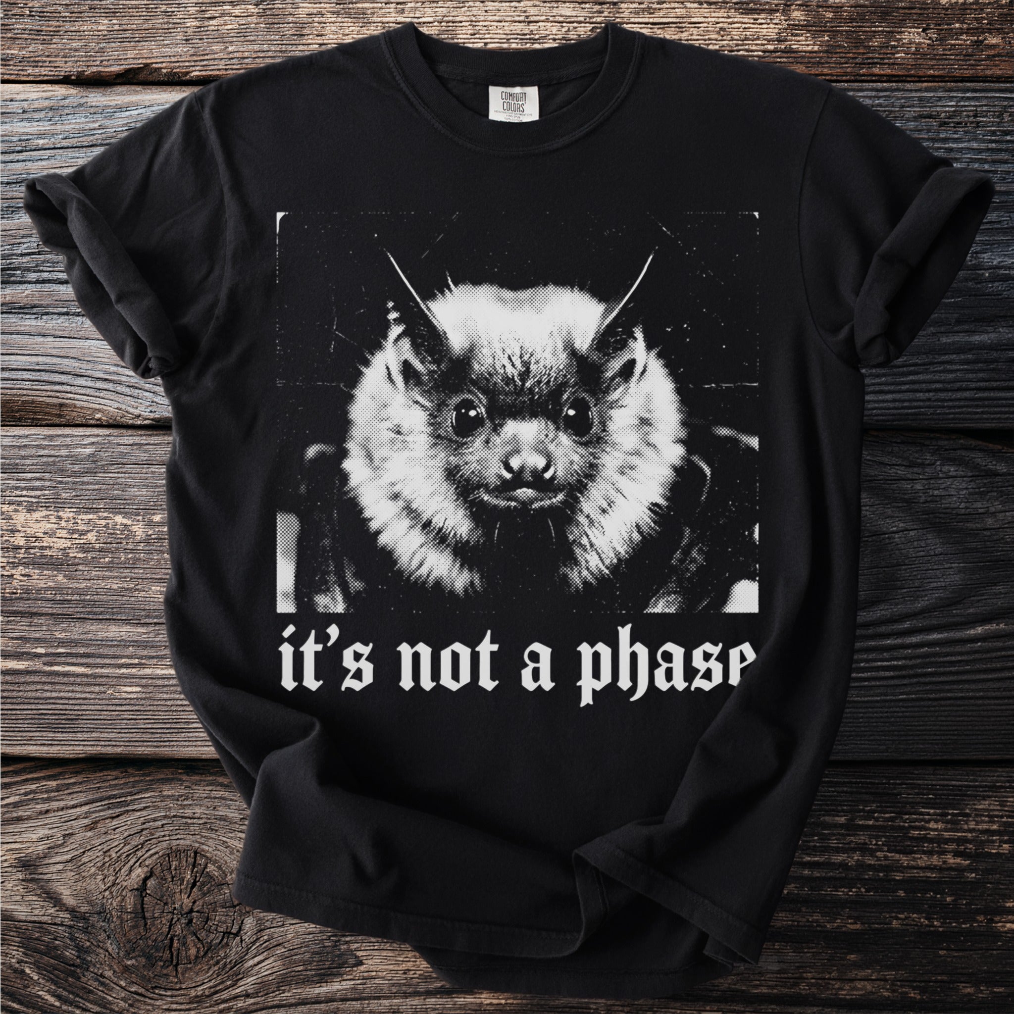 Black t-shirt with a close-up of a bat and "it's not a phase" text.