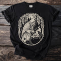 Black t-shirt with a circular linocut design of a witch brewing a potion with a crow.