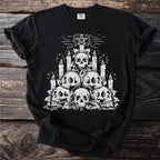 Black t-shirt with a white graphic of skulls, candles, and a pentagram.