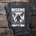 Dark t-shirt with white text and a Mothman image: "MISSING LAST SEEN: POINT PLEASANT, 1967 ANSWERS TO: NOTHING".